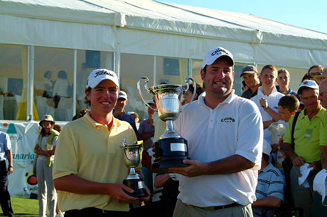 Young and adult person holding golf trophies at event in Tenerife.
