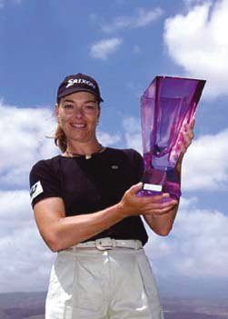 Woman holding a purple trophy on a sunny day in Tenerife.