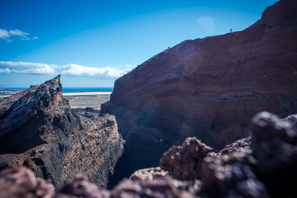 Volcanic landscape with dark cliffs and sea view in Tenerife.