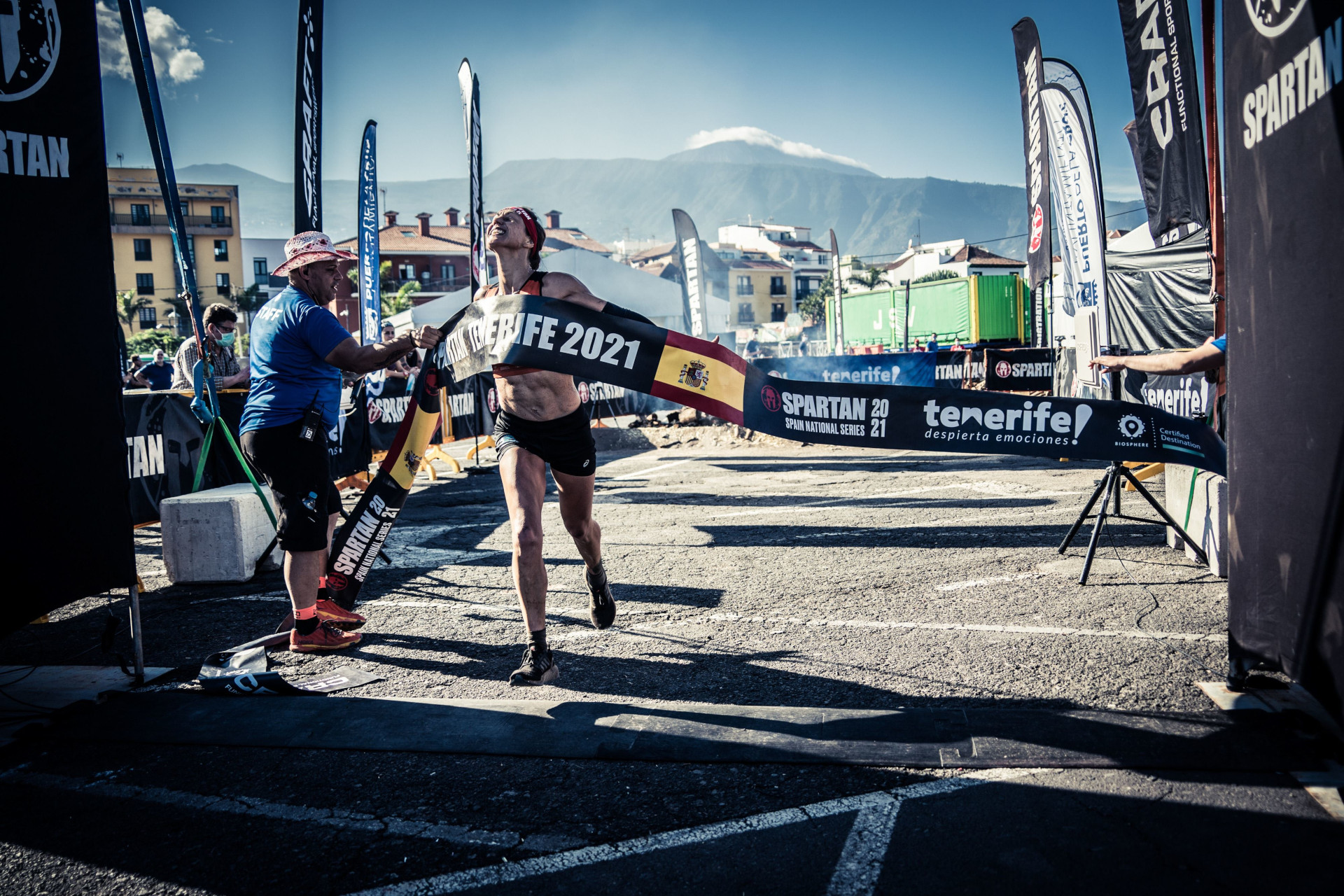 Runner crossing the finish line at the Spartan Tenerife 2021 with Mount Teide in the background.
