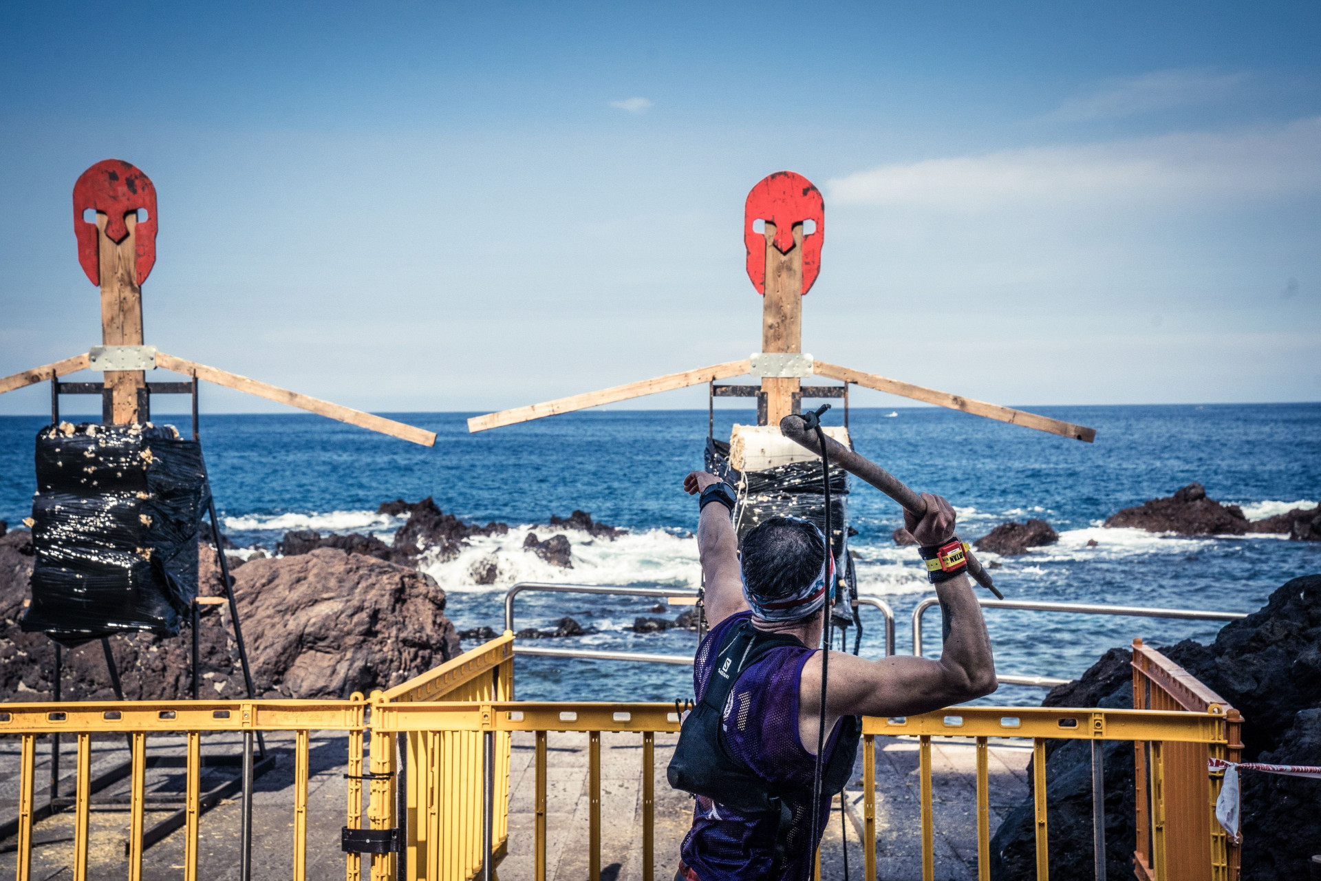 Competitor throws axe towards target on the coast of Tenerife.