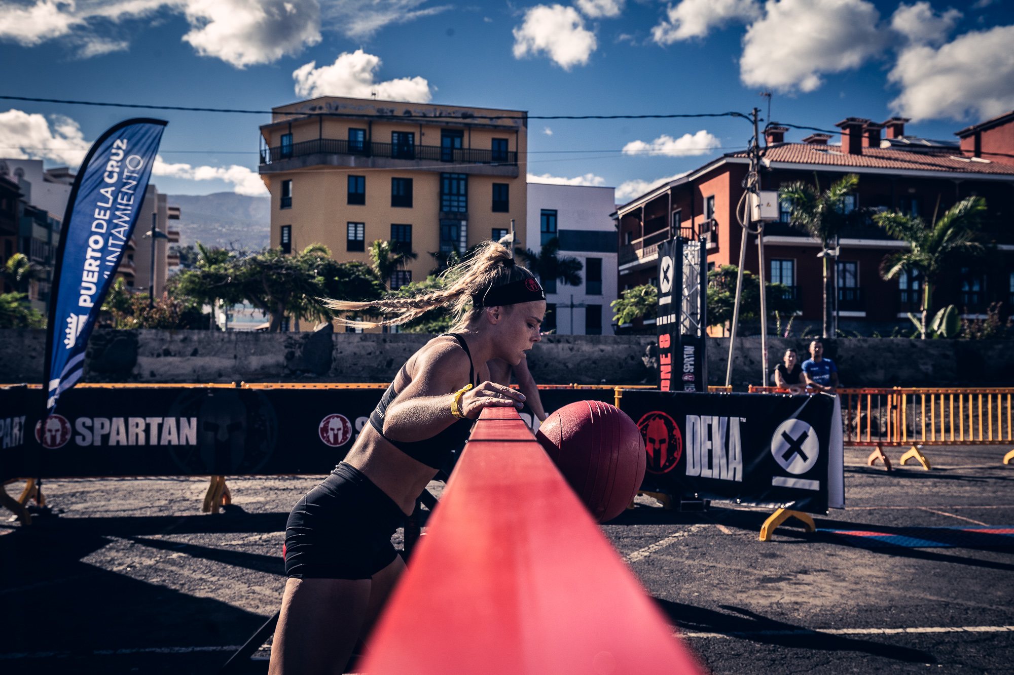Athlete in Spartan competition in Puerto de la Cruz, Tenerife. Banner says CITY HALL.