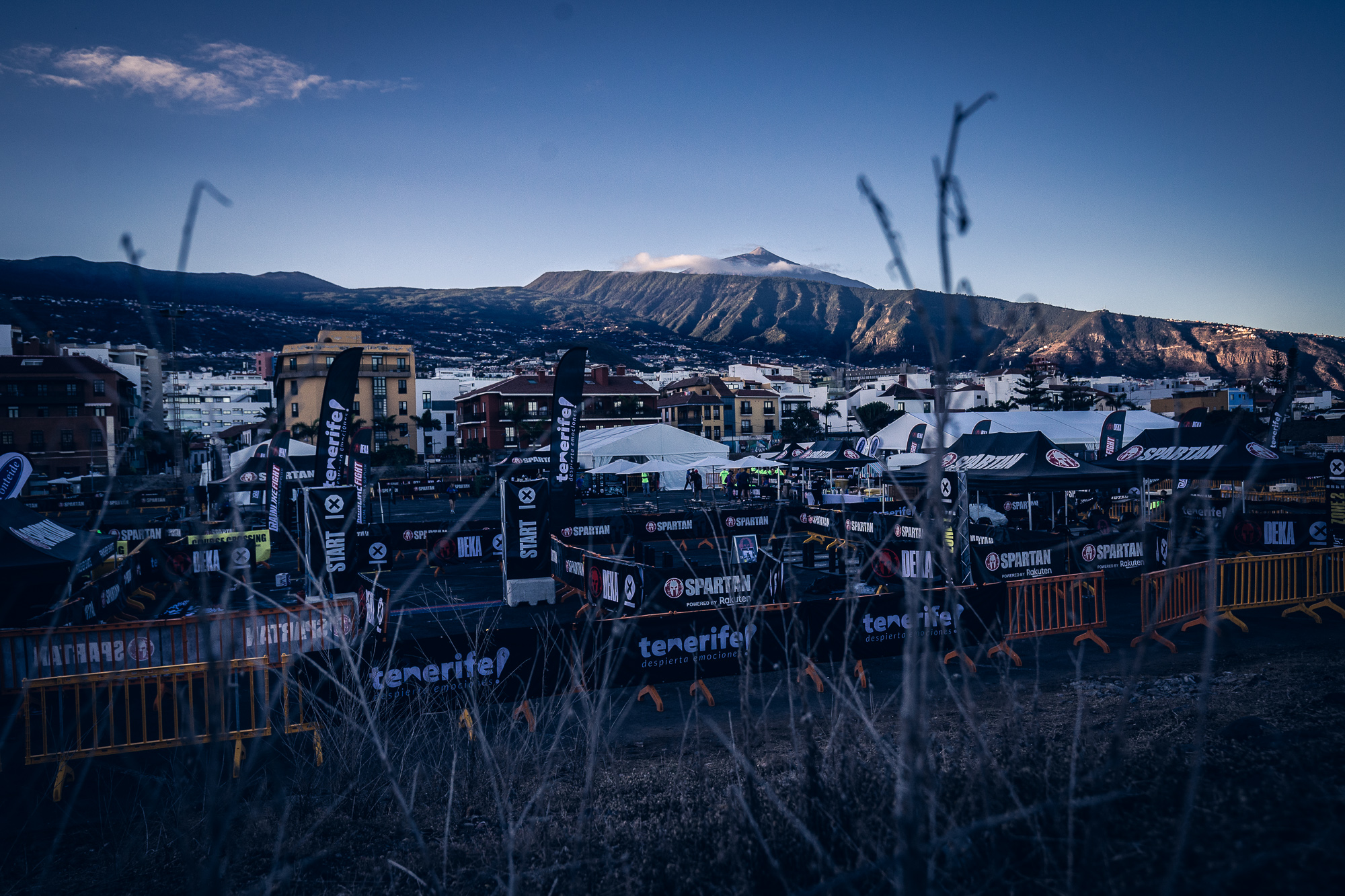 Sporting event in Tenerife with Mount Teide in the background and Spartan Race tents.