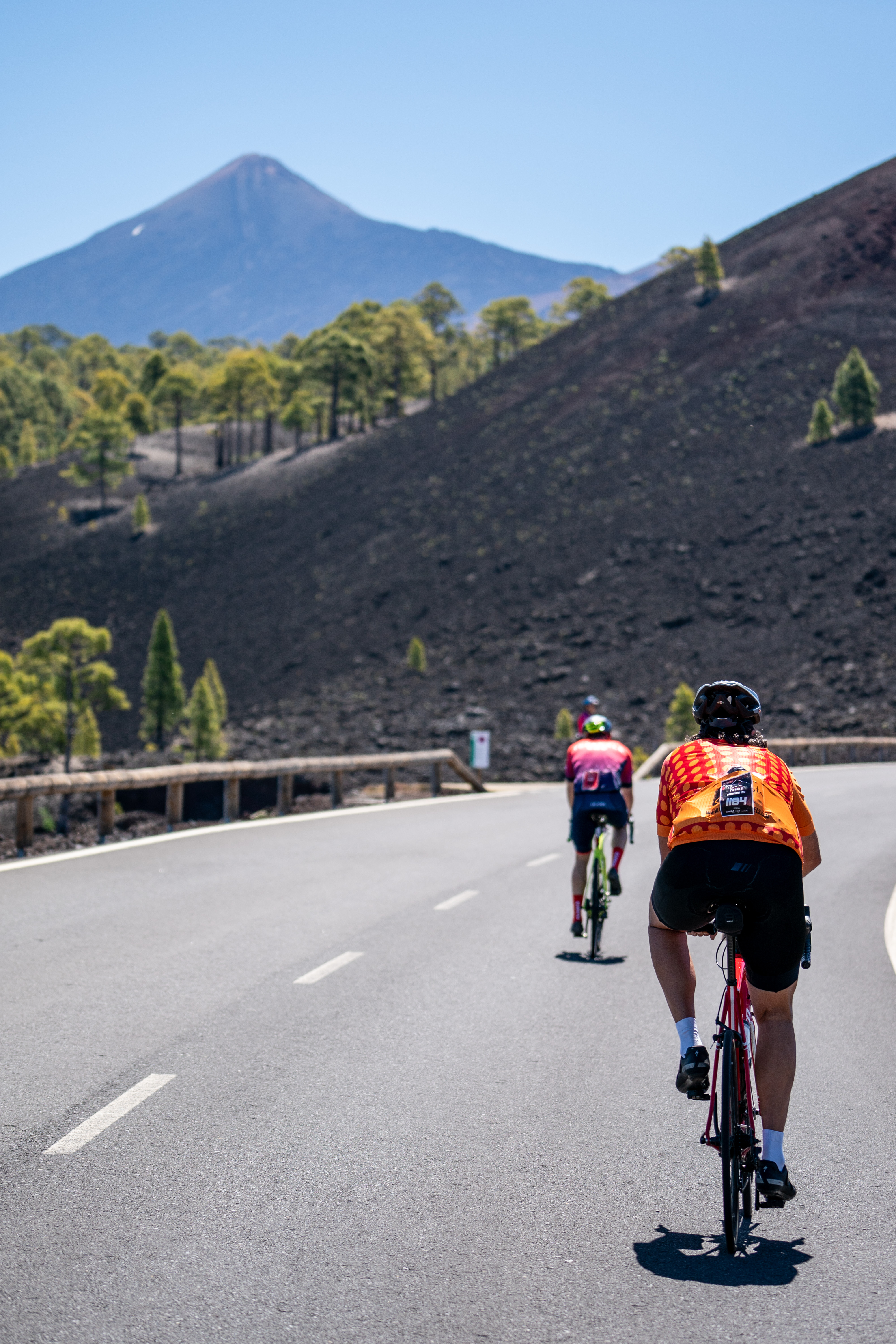 Cyclists on asphalt road near Mount Teide in Tenerife.