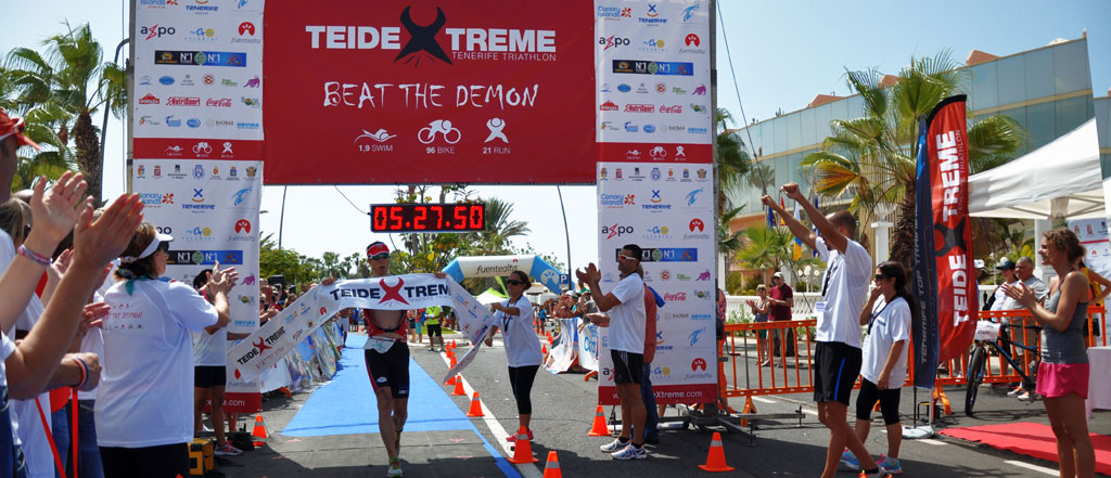 Runner crossing the finish line in the Teide Xtreme Tenerife triathlon.
