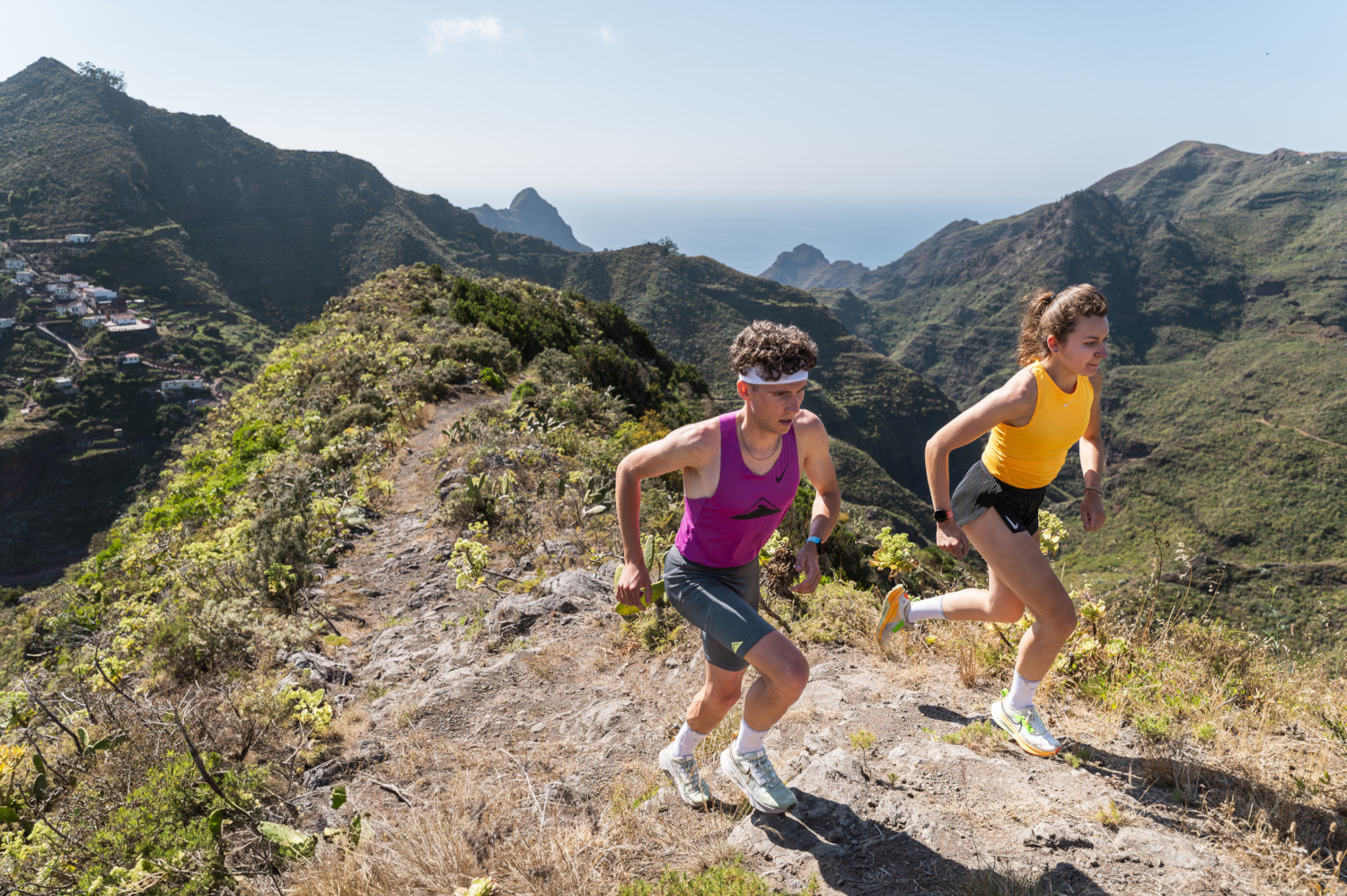 People running on mountainous trails in Tenerife.