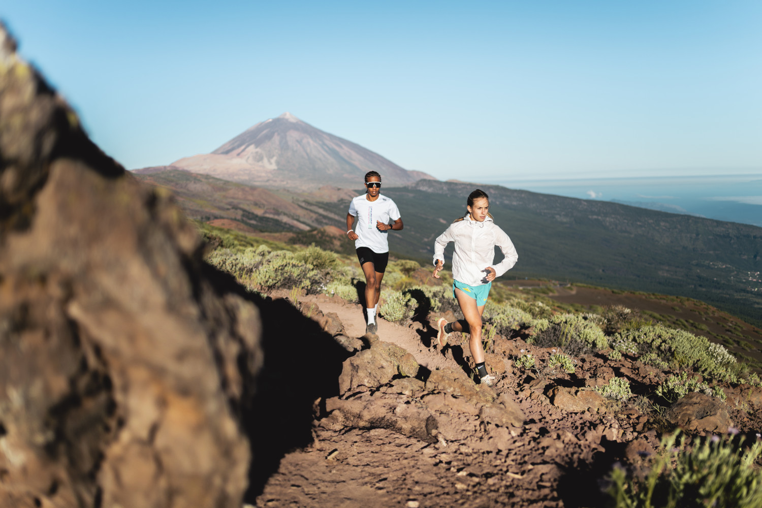 Runners on a trail with Mount Teide in the background, Tenerife.