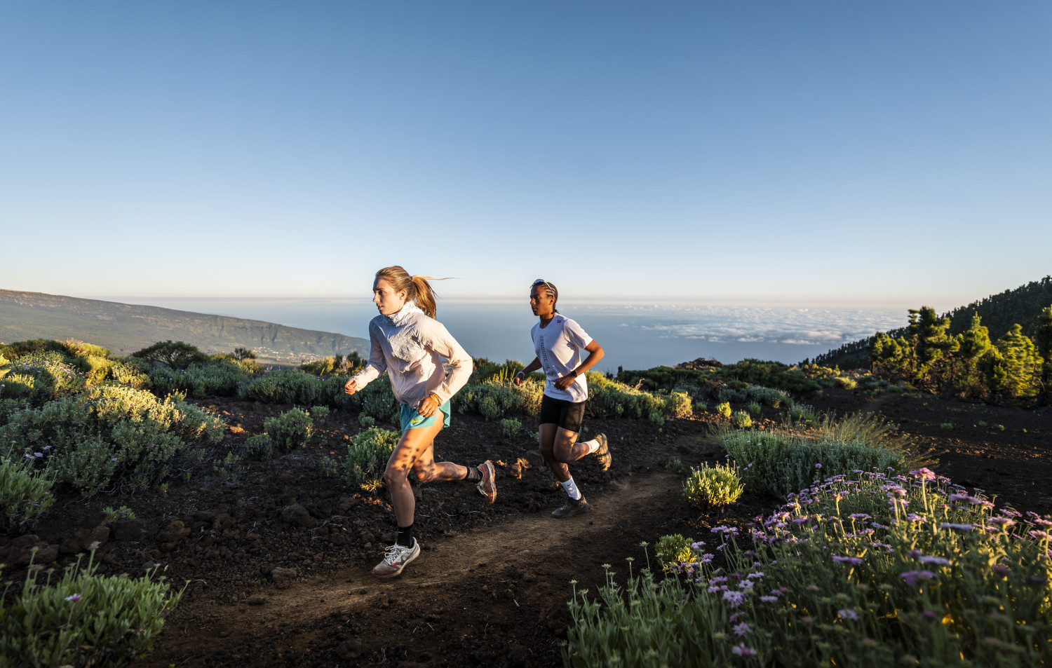 People running along a path with sea views in Tenerife.