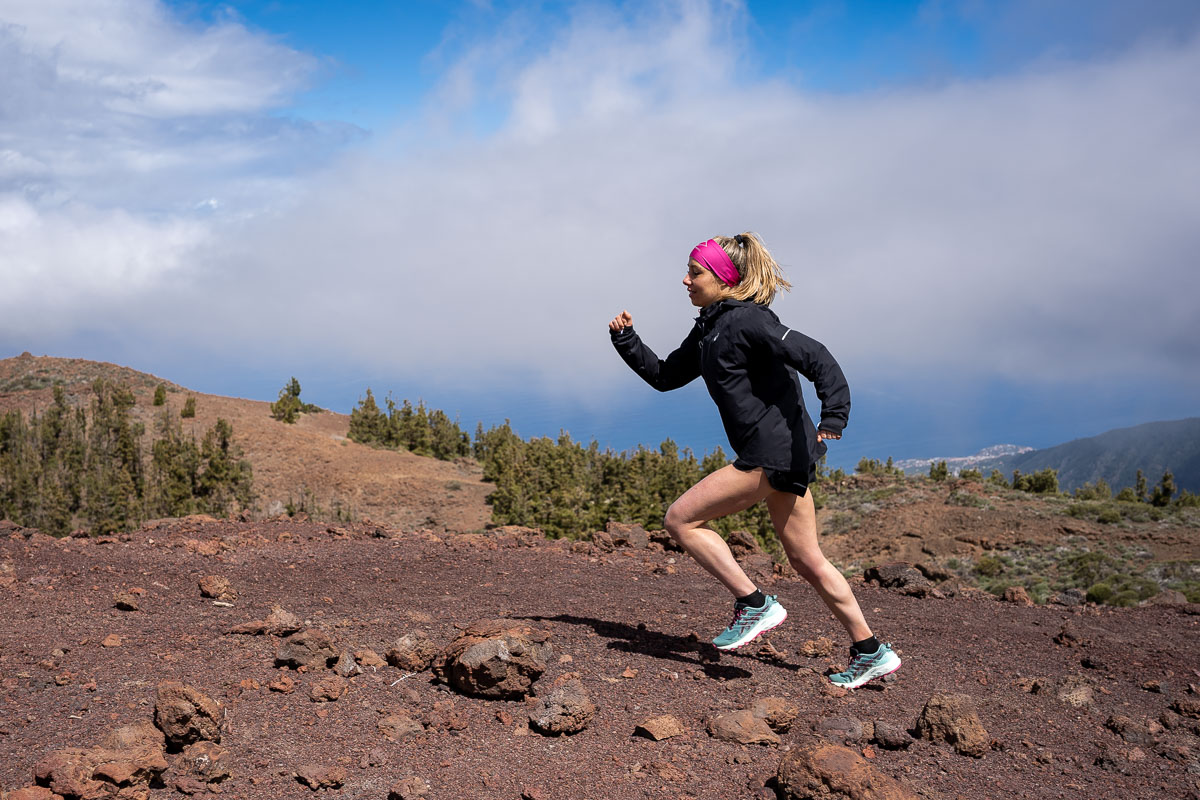 Woman running in a mountainous landscape in Tenerife.