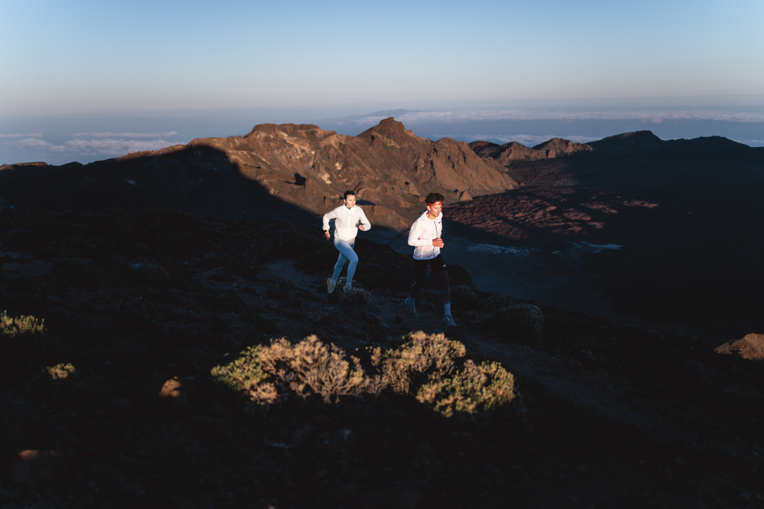 Two people running at dawn in Teide National Park, Tenerife.