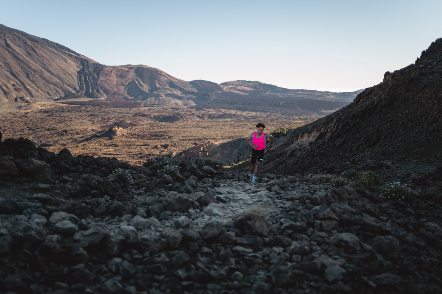 Person running on rocky trail in Teide National Park, Tenerife.
