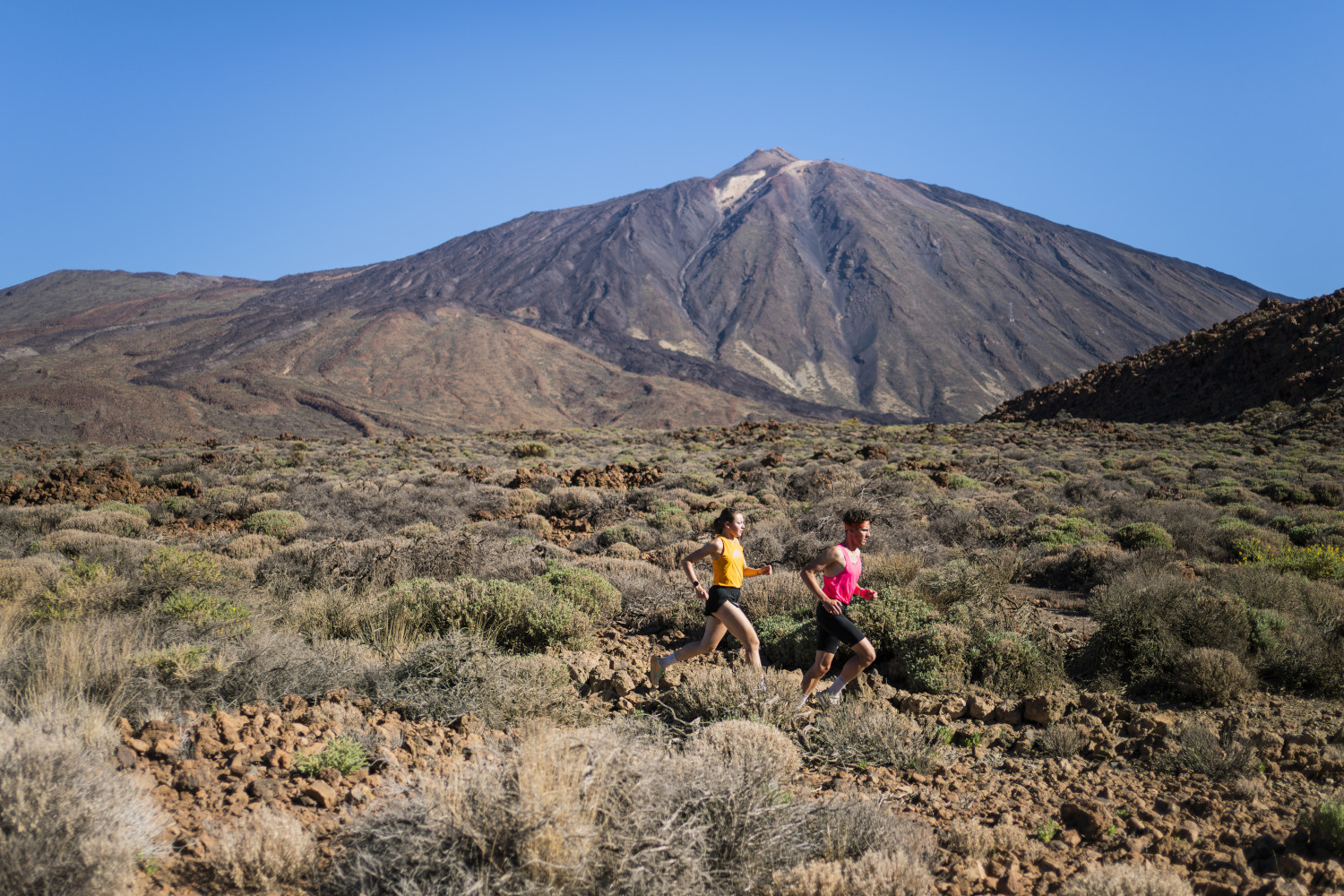 People running on a trail near Mount Teide in Tenerife.