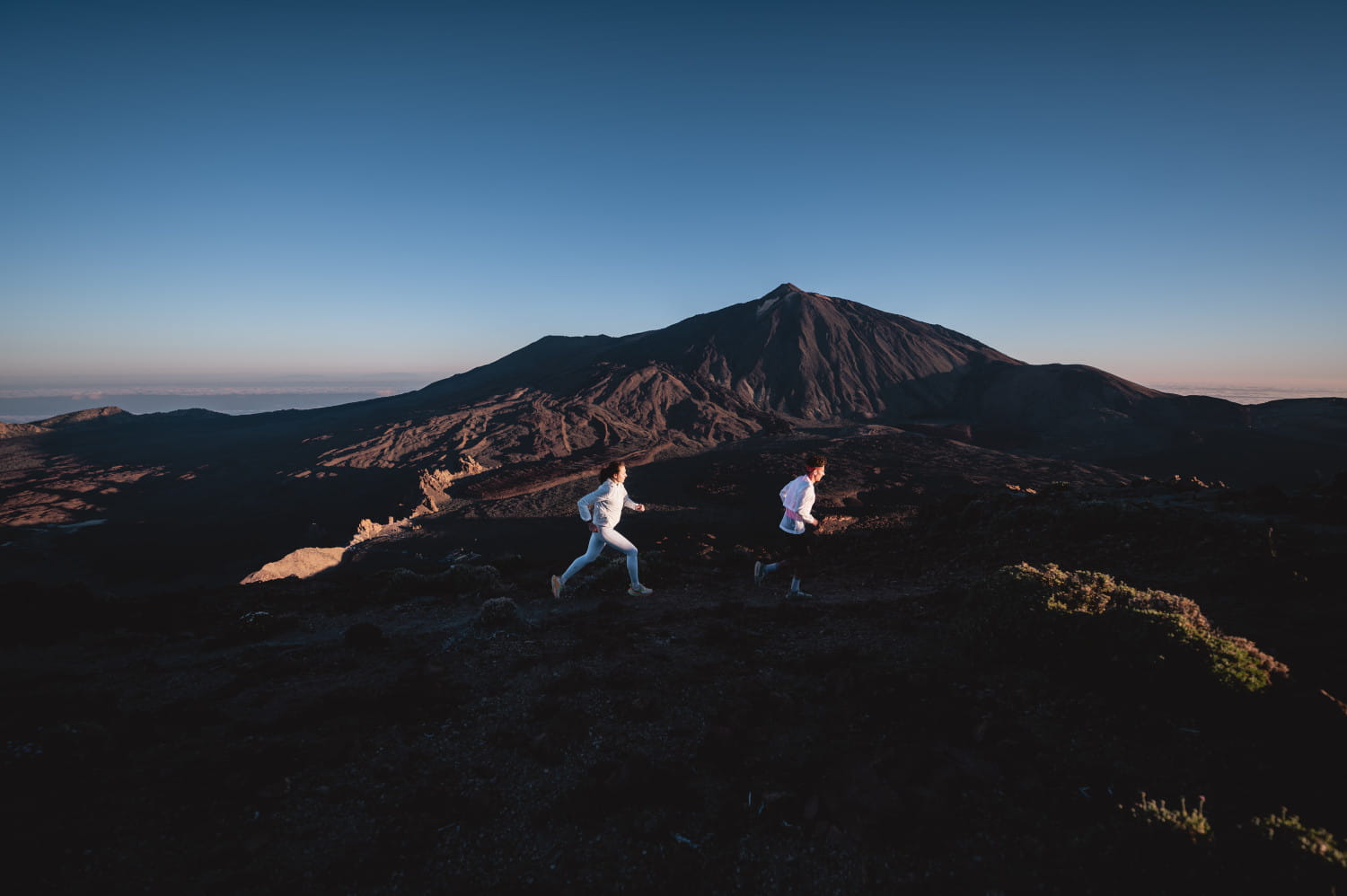 People running in Teide National Park at dawn, Tenerife.