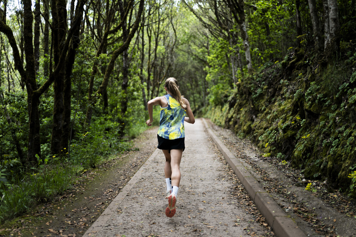 Runner on a green path in Anaga, Tenerife.
