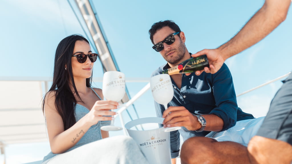 People toasting with Moët & Chandon champagne on a yacht in Tenerife.