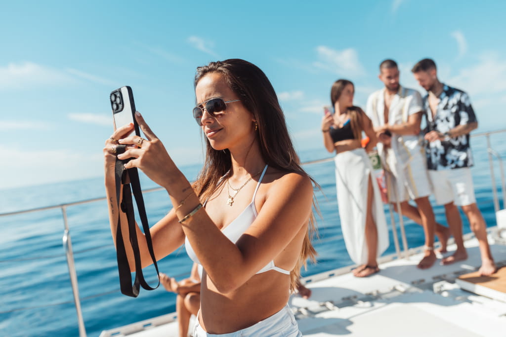 Woman taking photos while sailing on a boat in Tenerife.