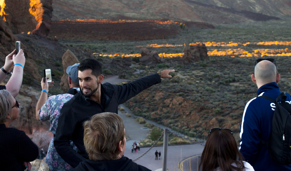 Guide pointing out volcanic landscape in Teide National Park, Tenerife.