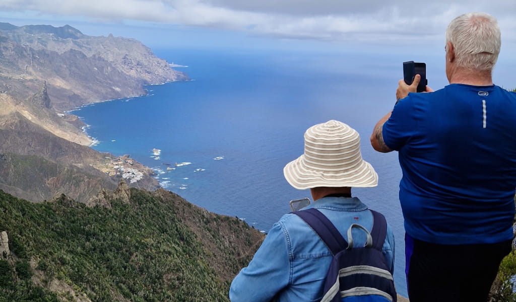 People taking photos of the coastal landscape in Tenerife.