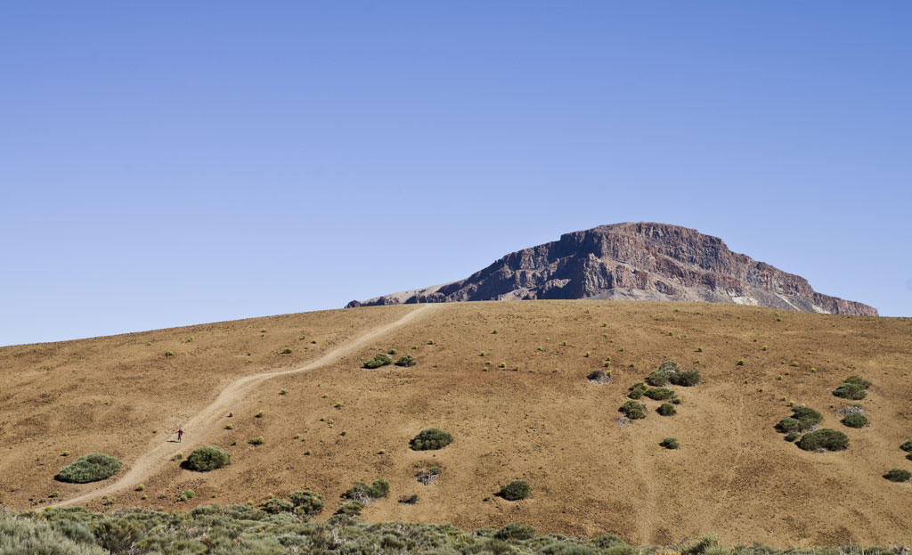 Trail in the Teide National Park, Tenerife, with mountain in the background.