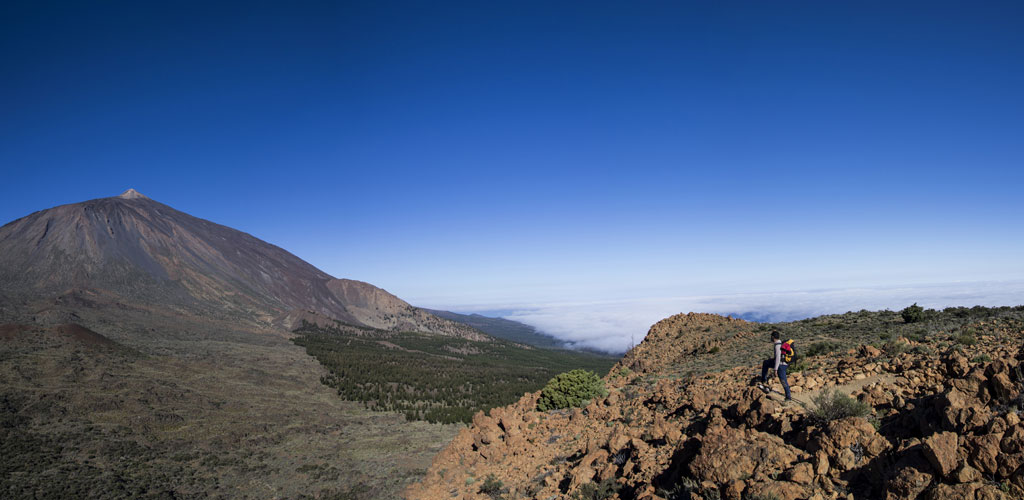 Hiker in the Teide National Park, Tenerife, with the volcano in the background.