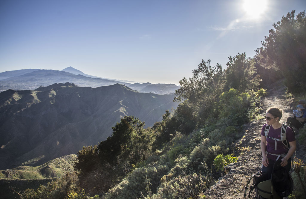 Hiker on the mountain trail overlooking Mount Teide in Tenerife.