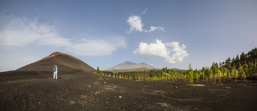 Volcanic trail in Teide National Park, Tenerife, with walker in the distance.