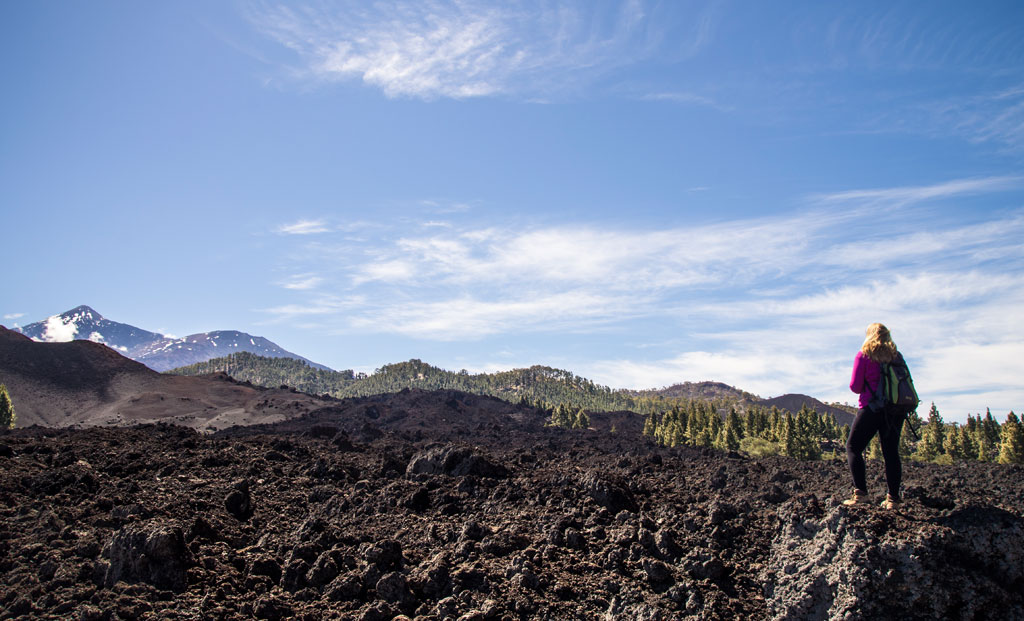 Person walking on lava fields near Mount Teide, Tenerife.