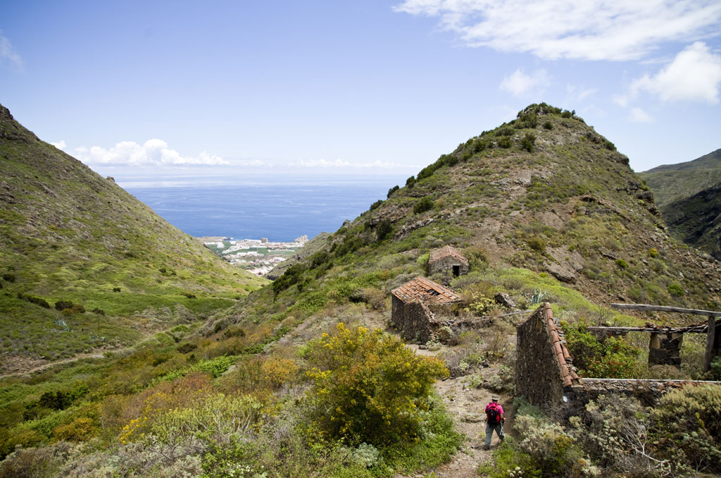 Mountainous valley with ruins and sea view in Tenerife.