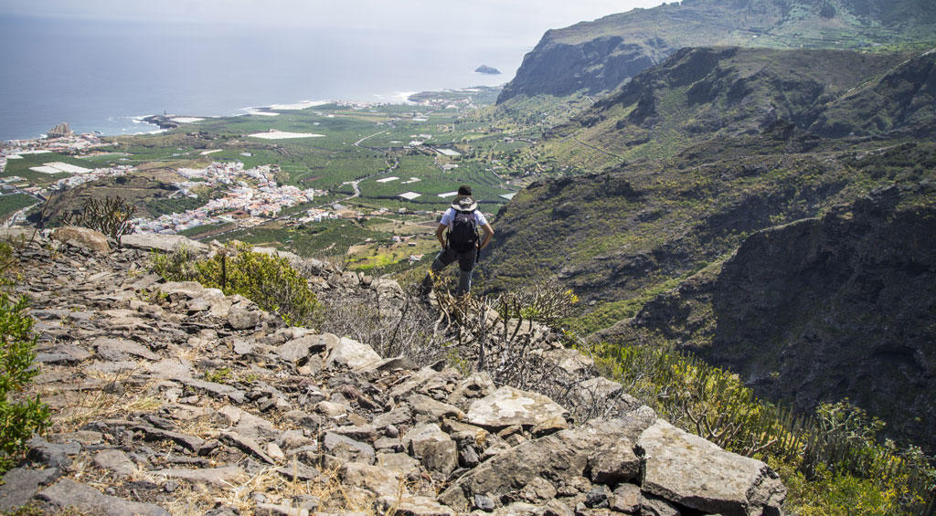 Person walking in the mountains overlooking the valley of Buenavista del Norte, Tenerife.