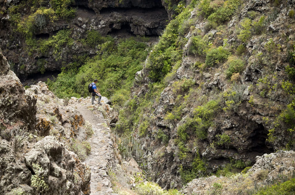Trail in the Masca ravine, Tenerife, with hiker walking.