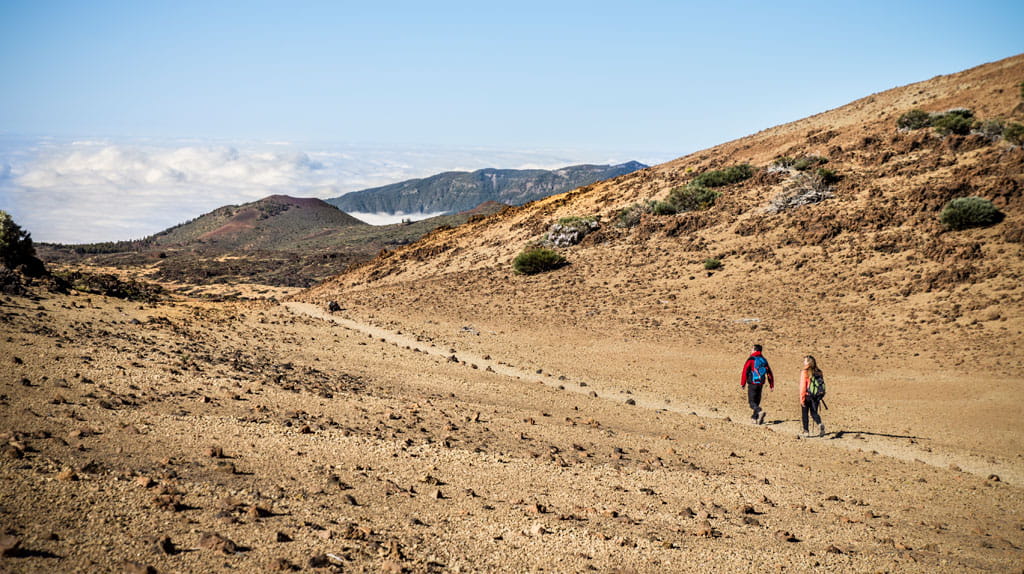 Two people walking on a trail in Teide National Park, Tenerife.