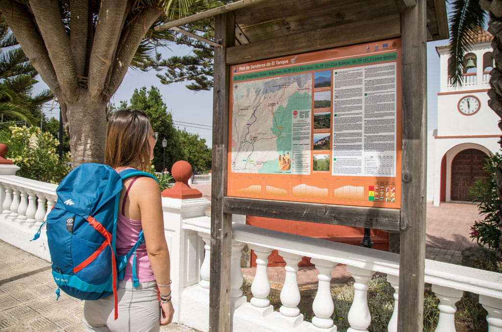 Woman looking at trail sign in El Tanque, Tenerife.