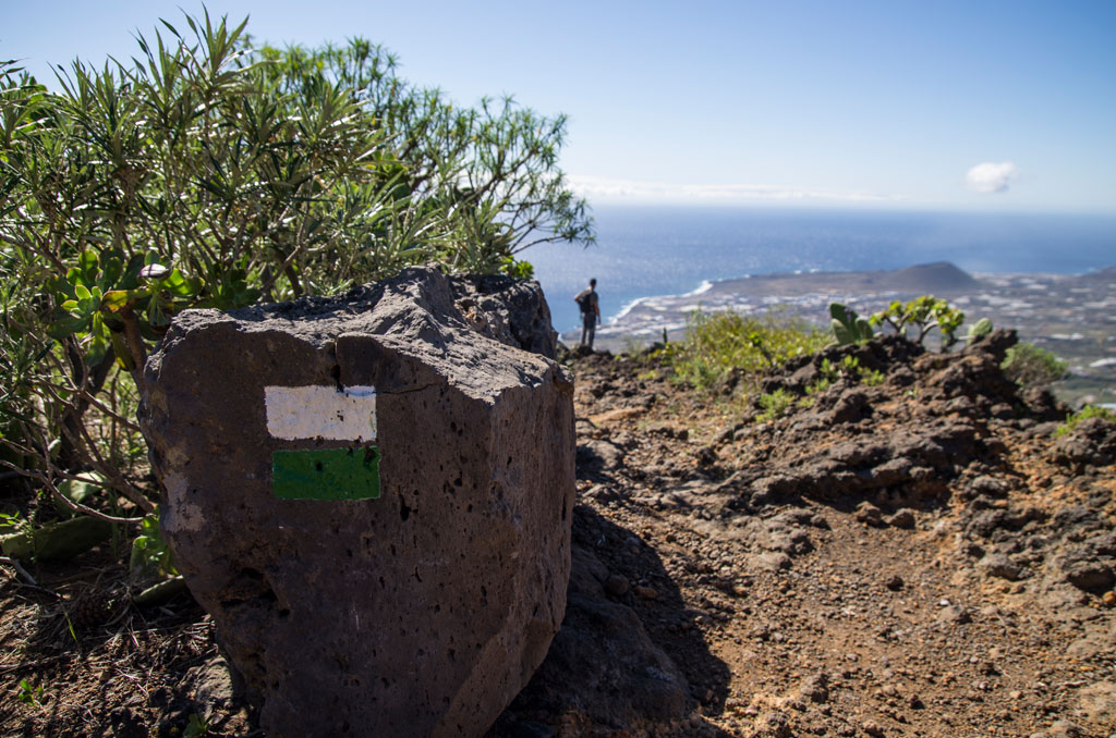 Trail in Tenerife with marked rock and sea views.