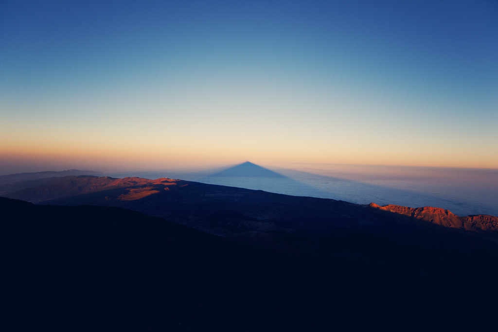 Shadow of Mount Teide cast over the sea at sunset in Tenerife.