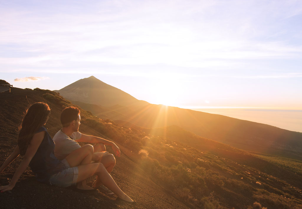 Couple watching the sunset on Mount Teide, Tenerife.