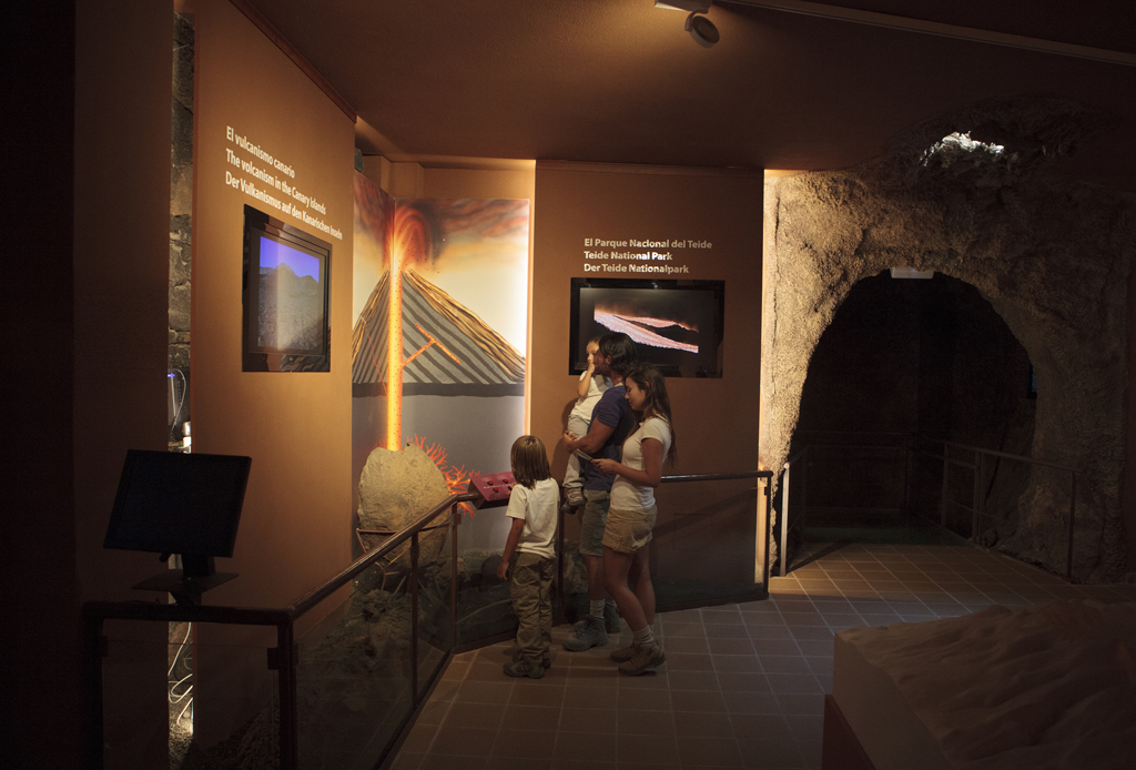 Family observes exhibition on volcanism in Teide National Park, Tenerife.