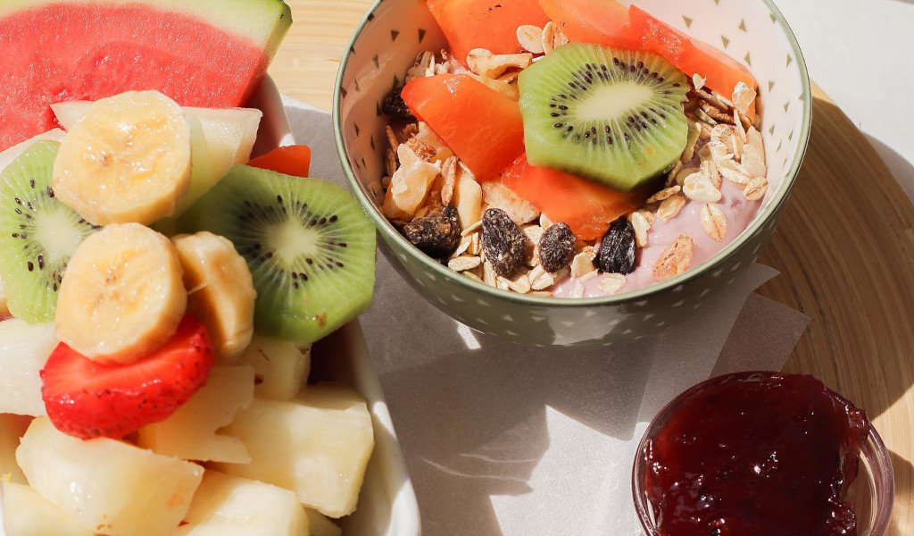 A bowl of yoghurt with kiwi, papaya, muesli and fresh fruit in Tenerife.