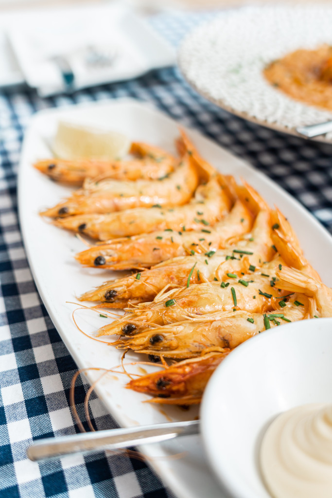 Garlic prawns served on a white plate in a restaurant in Tenerife.
