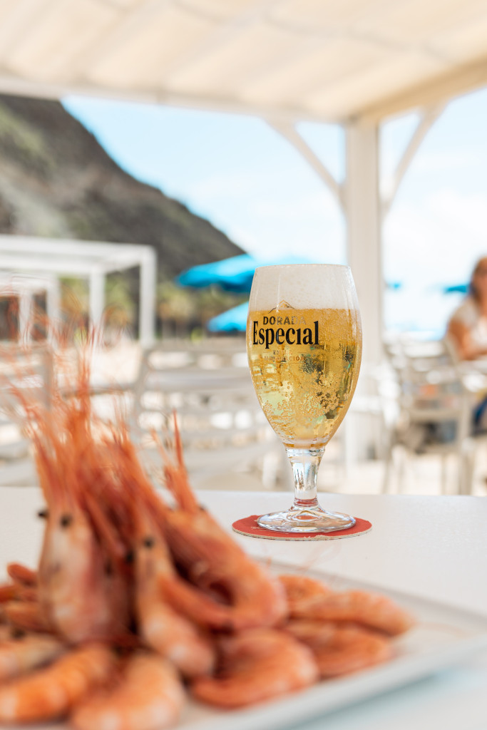 Glass of Special Golden Beer with prawns on the terrace in Tenerife.