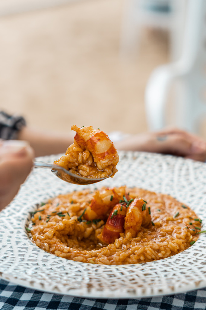 Seafood risotto on a decorated plate, served by the sea in Tenerife.