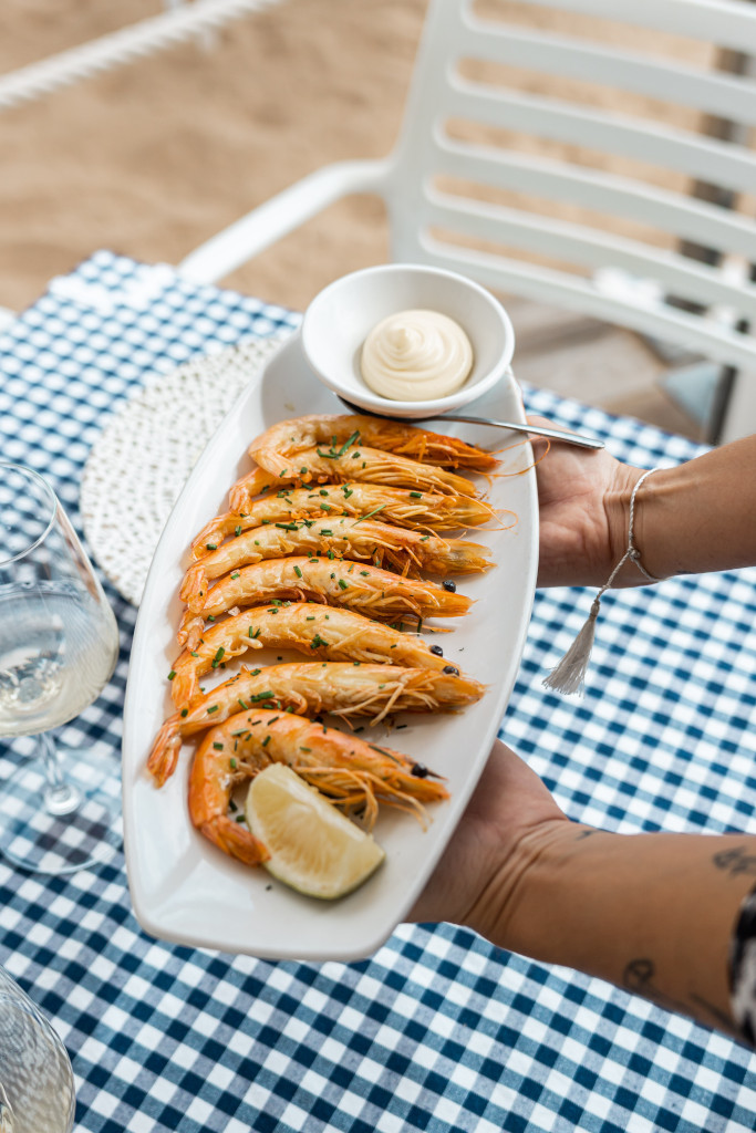 Prawns with lemon and sauce on a plate on the table in Tenerife.