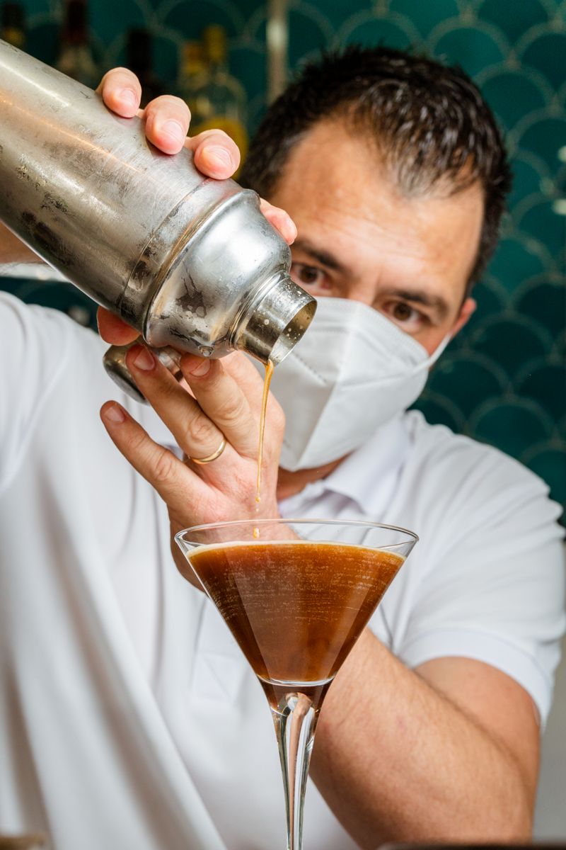 Mixologist serving drink in Martini glass in Tenerife.