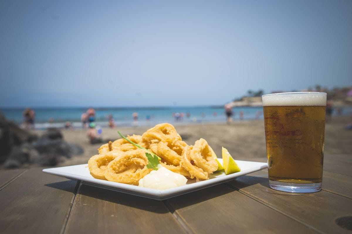 Fried squid with lemon and beer on the beach of Adeje, Tenerife.