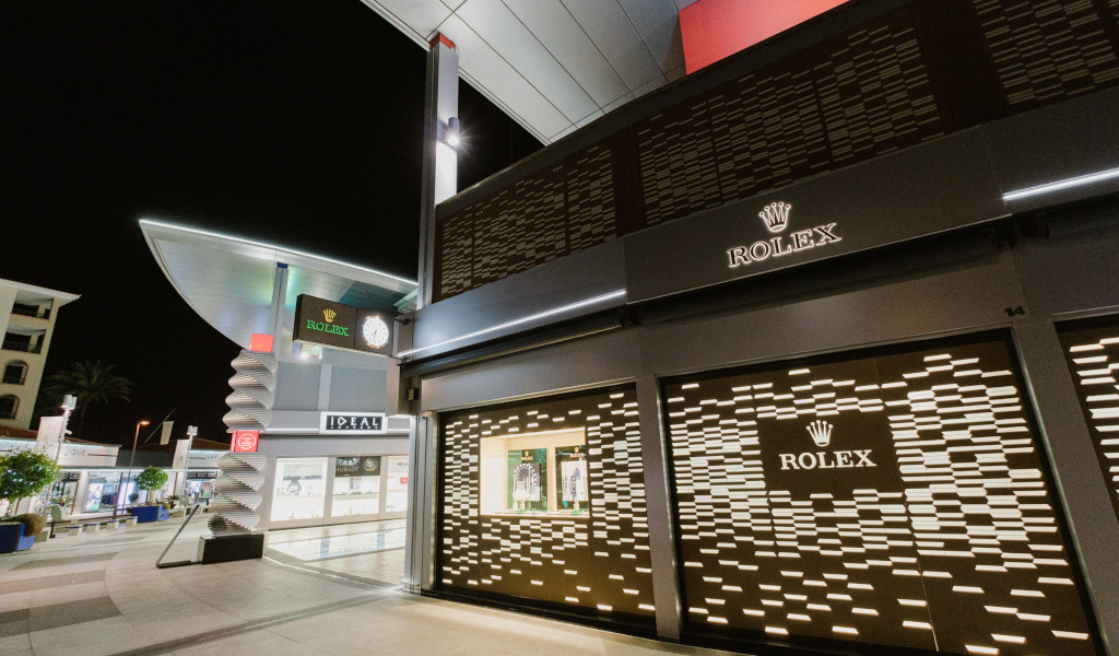 Rolex store illuminated at night in a shopping centre in Tenerife.