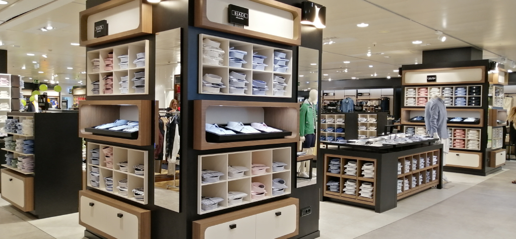 Shirts displayed on shelves inside a clothing store in Tenerife.