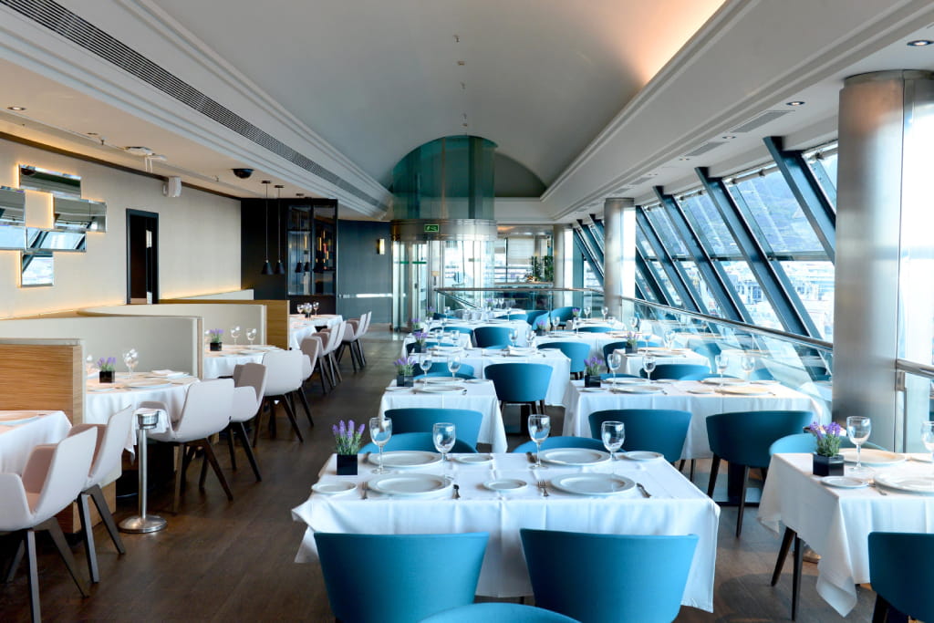 Elegant dining room with tables prepared in a restaurant with an exterior view in Tenerife.