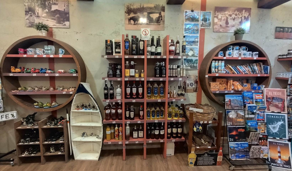 Souvenir shop in Tenerife with bottles of liquor and postcards from El Teide.