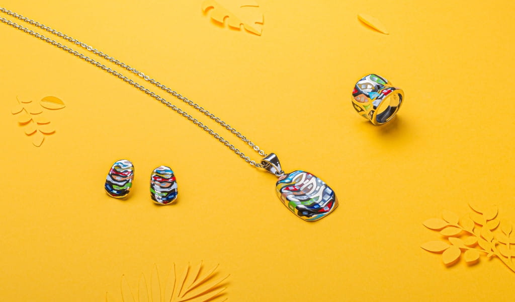 Colorful necklace, earrings and ring on yellow background, Tenerife.