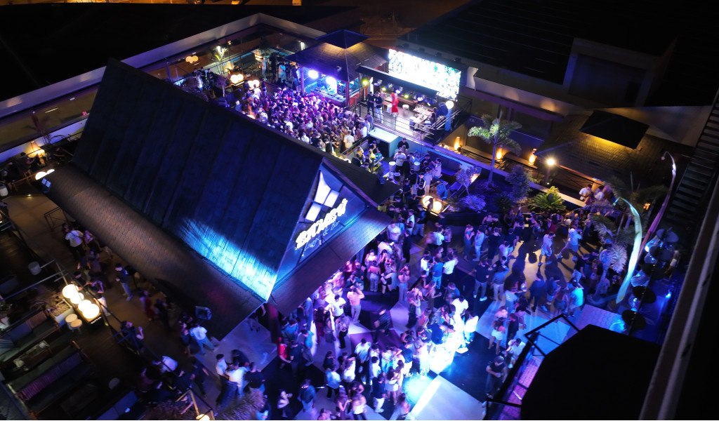 Crowds of people in an illuminated nightclub in Playa de las Américas, Tenerife.