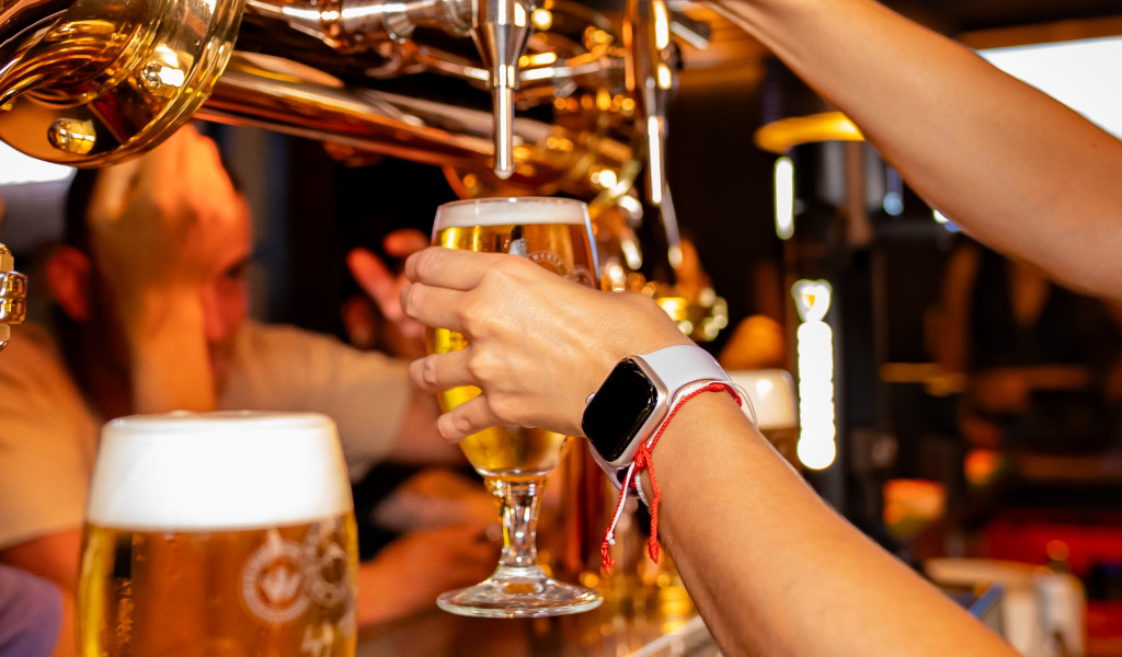 Hand pouring beer on tap in bar in Tenerife.